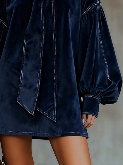 Mini dress in dark blue velvet with bow and lantern sleeves